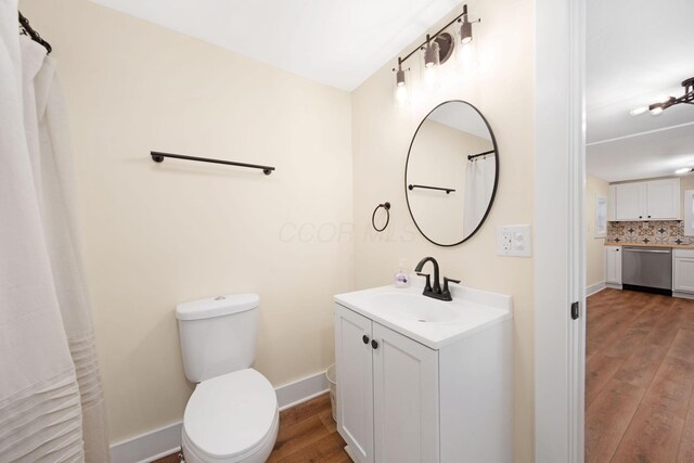 11 E Main St, Sparta, OH 43350 - bathroom featuring wood finished floors, vanity, and backsplash