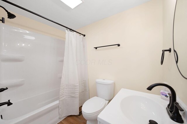 11 E Main St, Sparta, OH 43350 - full bath with shower / bath combo with shower curtain, vanity, and wood finished floors