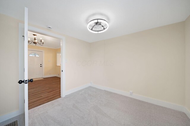 11 E Main St, Sparta, OH 43350 - empty room with carpet floors and a chandelier