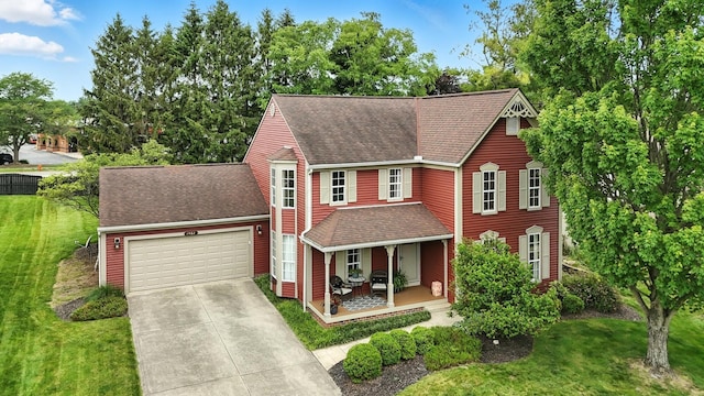 1482 Buckpoint Ln, Worthington, OH 43085 - view of front facade with covered porch, driveway, a garage, a front yard, and a shingled roof