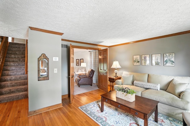 1482 Buckpoint Ln, Worthington, OH 43085 - living area featuring crown molding, light wood-style flooring, stairs, and a textured ceiling