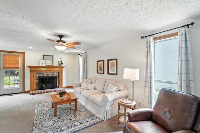 1482 Buckpoint Ln, Worthington, OH 43085 - carpeted living room featuring ceiling fan, a textured ceiling, and a brick fireplace