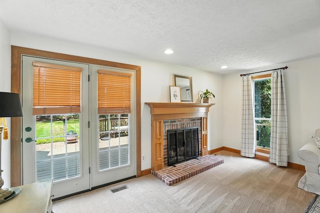 1482 Buckpoint Ln, Worthington, OH 43085 - carpeted living room with a brick fireplace, recessed lighting, and a textured ceiling