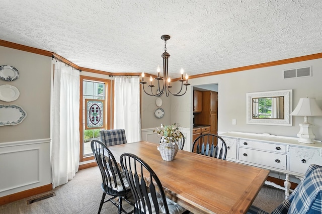 1482 Buckpoint Ln, Worthington, OH 43085 - dining space with a chandelier, ornamental molding, a textured ceiling, wainscoting, and a decorative wall