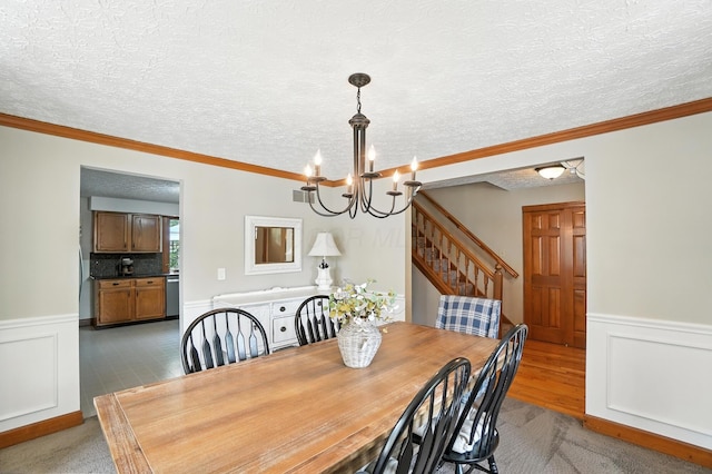 1482 Buckpoint Ln, Worthington, OH 43085 - dining area with a chandelier, wainscoting, a textured ceiling, ornamental molding, and stairs