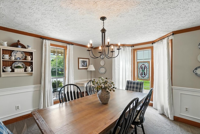 1482 Buckpoint Ln, Worthington, OH 43085 - dining area with ornamental molding, a chandelier, a wainscoted wall, and light colored carpet