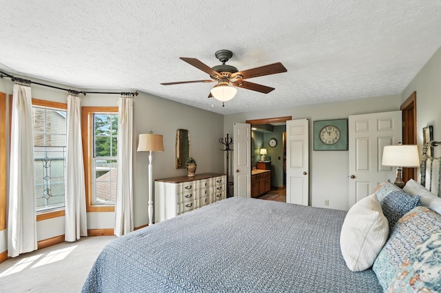 1482 Buckpoint Ln, Worthington, OH 43085 - carpeted bedroom featuring a textured ceiling, ensuite bath, and a ceiling fan