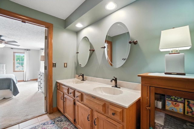 1482 Buckpoint Ln, Worthington, OH 43085 - ensuite bathroom featuring double vanity, ceiling fan, tile patterned floors, a textured ceiling, and recessed lighting