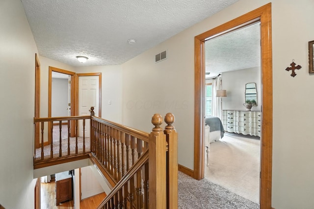 1482 Buckpoint Ln, Worthington, OH 43085 - corridor featuring an upstairs landing, a textured ceiling, and carpet