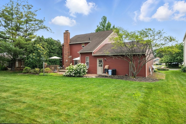 1482 Buckpoint Ln, Worthington, OH 43085 - rear view of property featuring a chimney, a yard, a wooden deck, and a shingled roof