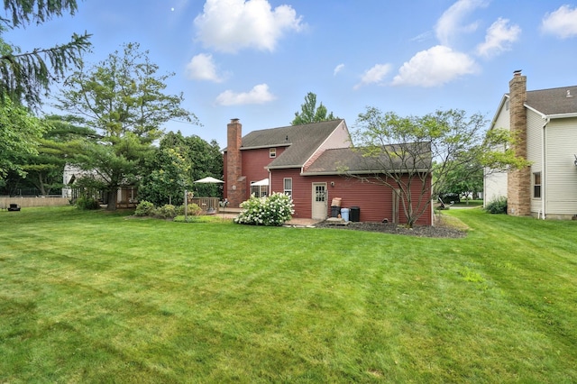 1482 Buckpoint Ln, Worthington, OH 43085 - back of property featuring a yard, a chimney, a wooden deck, and roof with shingles