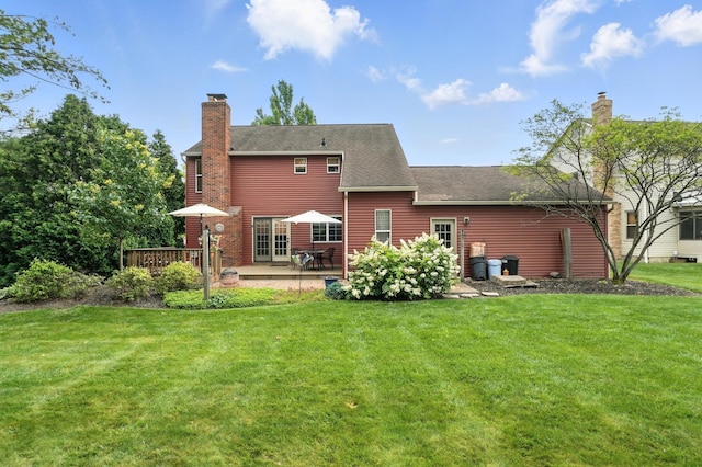 1482 Buckpoint Ln, Worthington, OH 43085 - rear view of property featuring a chimney, a lawn, a patio area, and roof with shingles