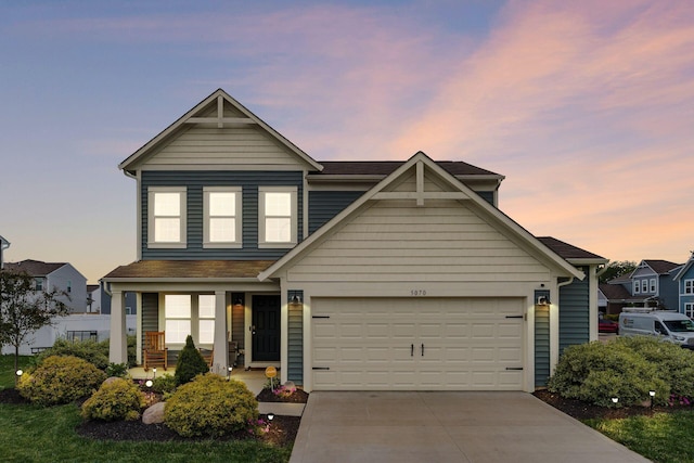 5070 River Bend Dr, South Bloomfield, OH 43103 - view of front facade featuring concrete driveway, a porch, a shingled roof, and a garage