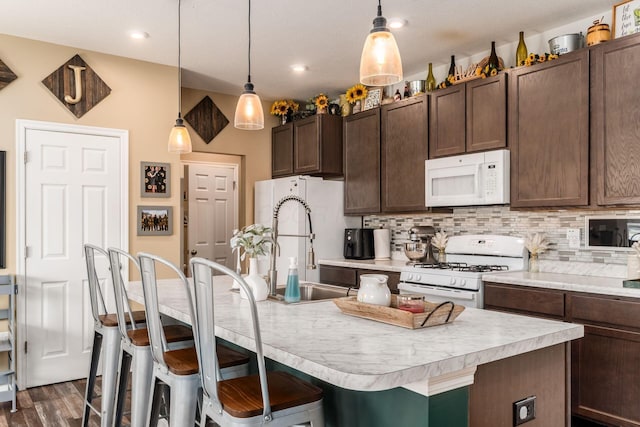 5070 River Bend Dr, South Bloomfield, OH 43103 - kitchen featuring white appliances, light countertops, decorative backsplash, a kitchen breakfast bar, and dark brown cabinetry