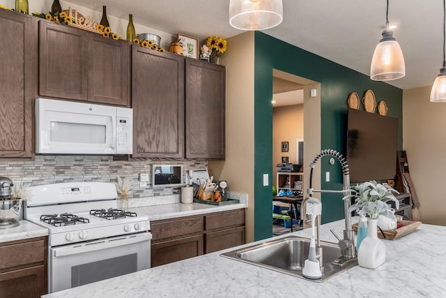 5070 River Bend Dr, South Bloomfield, OH 43103 - kitchen with white appliances, backsplash, and light countertops