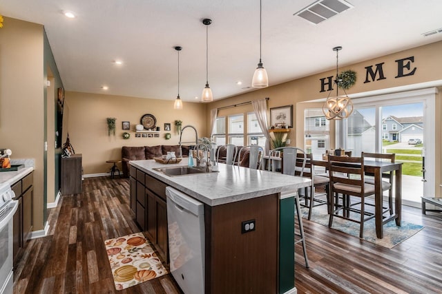 5070 River Bend Dr, South Bloomfield, OH 43103 - kitchen featuring dishwasher, a kitchen breakfast bar, dark wood-type flooring, light countertops, and pendant lighting