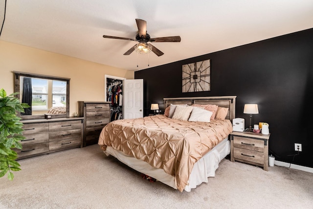 5070 River Bend Dr, South Bloomfield, OH 43103 - bedroom with light colored carpet, a walk in closet, a closet, and a ceiling fan