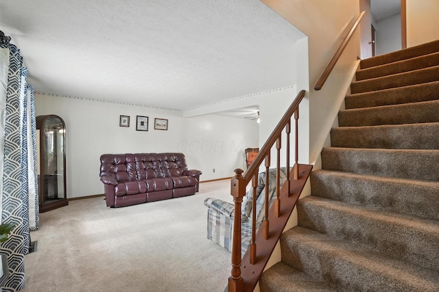 7207 Bride Water Blvd, Columbus, OH 43235 - staircase featuring carpet, a textured ceiling, and a ceiling fan
