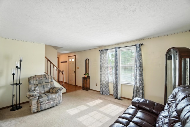 7207 Bride Water Blvd, Columbus, OH 43235 - living area featuring stairway, light colored carpet, and a textured ceiling