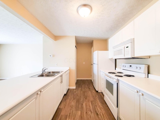 6149 Georges Park Dr Unit 9E, Canal Winchester, OH 43110 - kitchen with white appliances, a textured ceiling, wood finished floors, light countertops, and white cabinetry