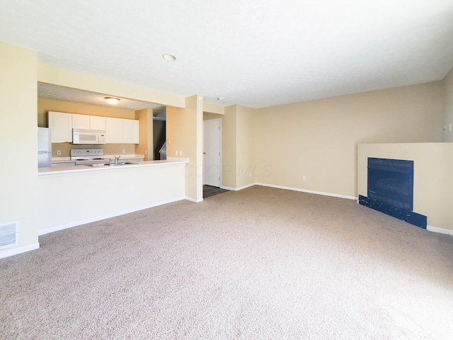 6149 Georges Park Dr Unit 9E, Canal Winchester, OH 43110 - unfurnished living room featuring carpet and a fireplace
