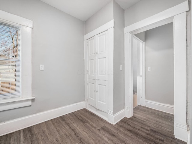 126 E 6th Ave Unit 126, Columbus, OH 43201 - unfurnished bedroom with dark wood-type flooring and baseboards