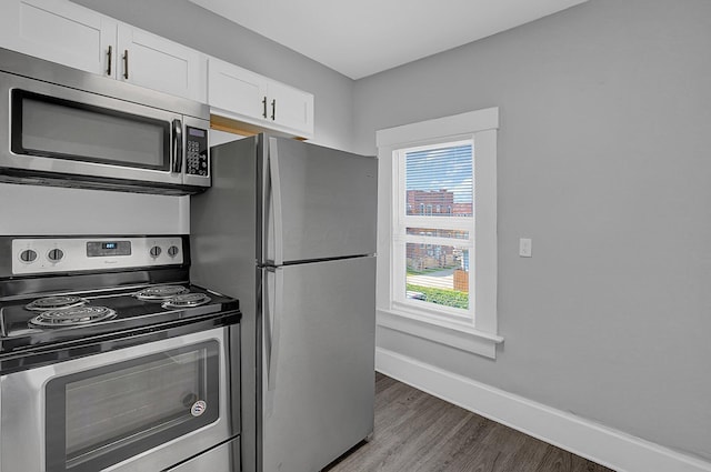 126 E 6th Ave Unit 126, Columbus, OH 43201 - kitchen with stainless steel appliances, wood finished floors, and white cabinets