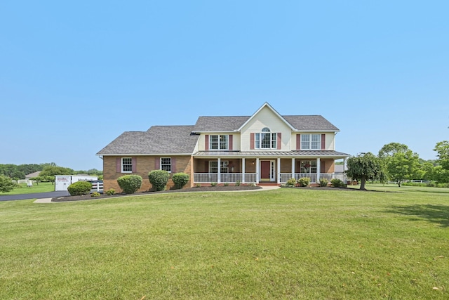 6281 Davis Dr, Newark, OH 43056 - colonial inspired home with covered porch, a front lawn, a standing seam roof, and a shingled roof