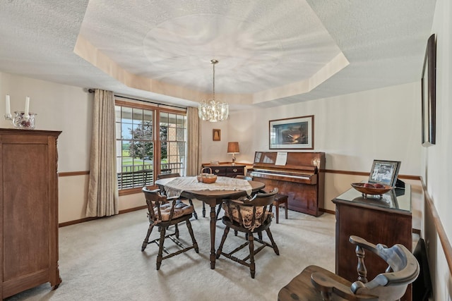 6281 Davis Dr, Newark, OH 43056 - dining area with a textured ceiling, light carpet, a tray ceiling, and a chandelier