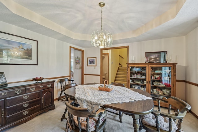 6281 Davis Dr, Newark, OH 43056 - dining space featuring light carpet, a chandelier, a tray ceiling, and stairway