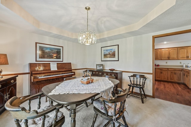 6281 Davis Dr, Newark, OH 43056 - dining room featuring a chandelier, light carpet, and a tray ceiling