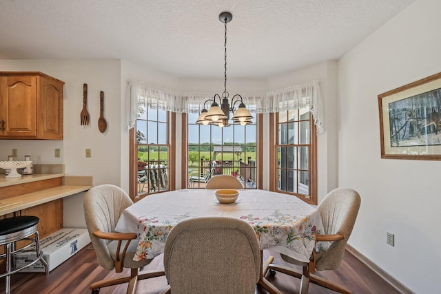 6281 Davis Dr, Newark, OH 43056 - dining area featuring wood finished floors, a chandelier, and a textured ceiling