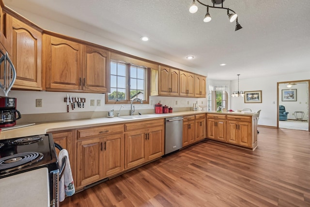 6281 Davis Dr, Newark, OH 43056 - kitchen featuring stainless steel dishwasher, a peninsula, dark wood-style floors, light countertops, and black range with electric stovetop