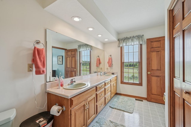 6281 Davis Dr, Newark, OH 43056 - full bathroom with healthy amount of natural light, double vanity, recessed lighting, and tile patterned floors