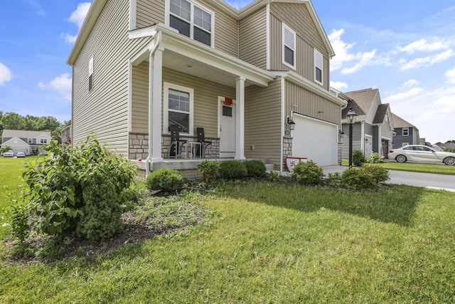 235 Old Bay Dr, Pataskala, OH 43062 - view of front of home with a porch, an attached garage, a front lawn, and driveway