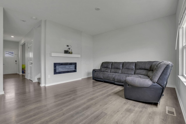 235 Old Bay Dr, Pataskala, OH 43062 - living area with wood finished floors, a glass covered fireplace, and recessed lighting