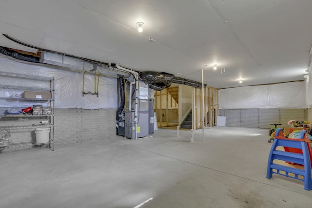 235 Old Bay Dr, Pataskala, OH 43062 - unfinished below grade area with heating unit, stairs, and brick wall