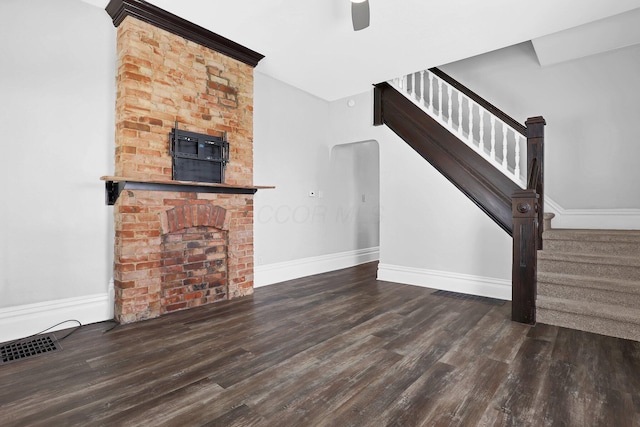 611 E 11th Ave, Columbus, OH 43211 - unfurnished living room featuring wood finished floors, stairway, and ceiling fan