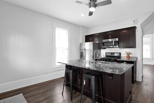 611 E 11th Ave, Columbus, OH 43211 - kitchen with appliances with stainless steel finishes, a breakfast bar area, healthy amount of natural light, and ceiling fan
