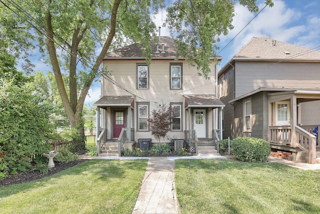 611 E 11th Ave, Columbus, OH 43211 - american foursquare style home featuring a front yard and roof with shingles