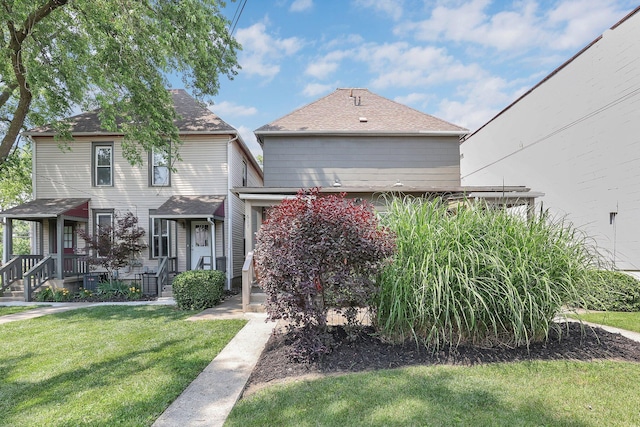 617 E 11th Ave, Columbus, OH 43211 - view of front facade with a front lawn and roof with shingles