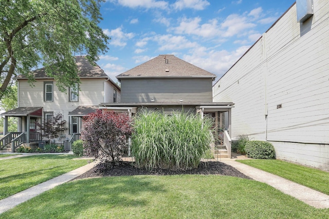 617 E 11th Ave, Columbus, OH 43211 - back of house with a lawn and roof with shingles