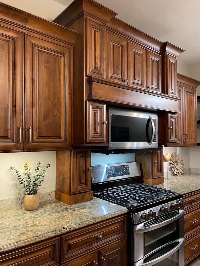 617 E 11th Ave, Columbus, OH 43211 - kitchen featuring appliances with stainless steel finishes and light stone counters