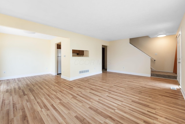 5198 Dierker Rd Unit D, Columbus, OH 43220 - unfurnished living room with light wood-style floors and stairs