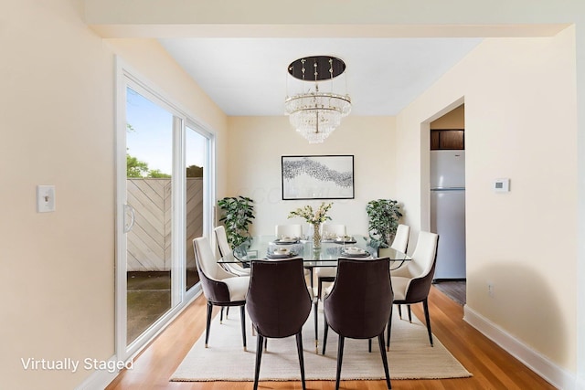 5198 Dierker Rd Unit D, Columbus, OH 43220 - dining area with wood finished floors and a chandelier