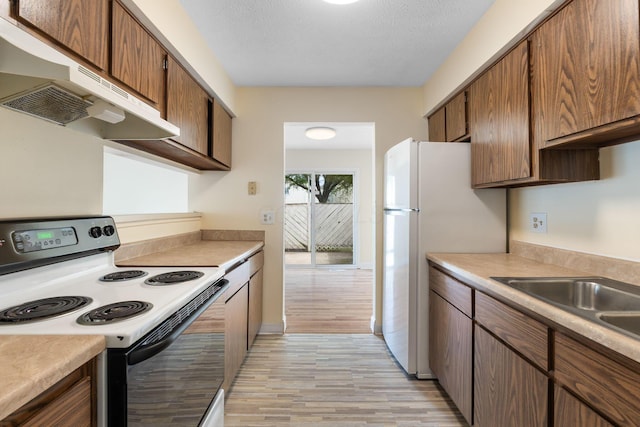 5198 Dierker Rd Unit D, Columbus, OH 43220 - kitchen with electric stove, under cabinet range hood, light wood-type flooring, light countertops, and freestanding refrigerator