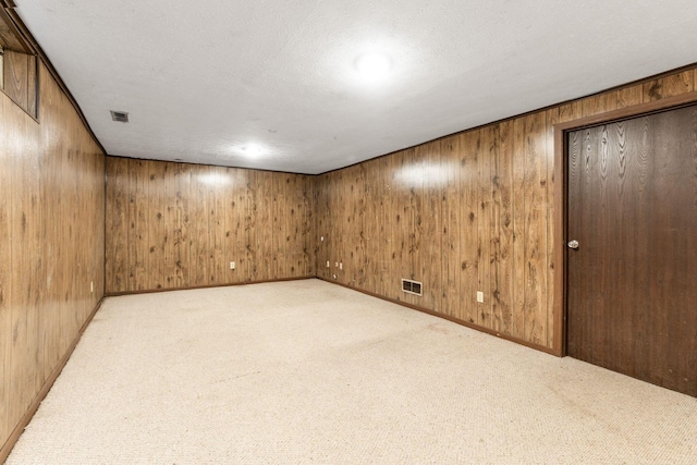 5198 Dierker Rd Unit D, Columbus, OH 43220 - finished basement with light colored carpet, wood walls, and a textured ceiling