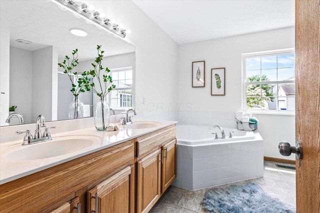 1280 Kariba Dr, Columbus, OH 43207 - bathroom featuring double vanity and a bath