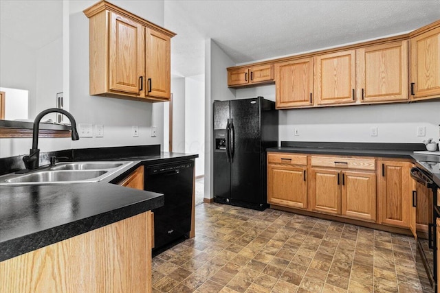 1280 Kariba Dr, Columbus, OH 43207 - kitchen featuring black appliances, dark countertops, and stone finish floors