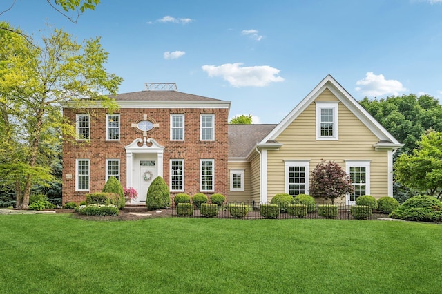 6150 Heritage Lakes Dr, Hilliard, OH 43026 - colonial home featuring a front yard, brick siding, and a shingled roof